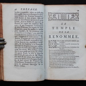May include: A page from an antique book with a title page for a poem called "The Temple of Renown." The text is in French and the page is decorated with a decorative border.