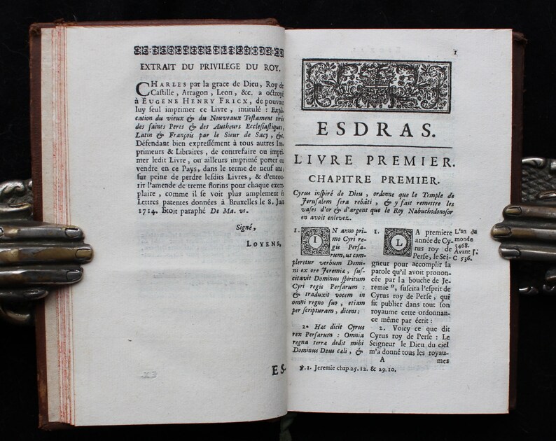May include: A page from an antique book with the title "ESDRAS" and the text "LIVRE PREMIER" in a decorative font. The page is yellowed with age and has a brown leather binding.