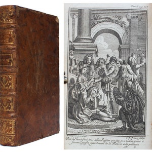 May include: A vintage leather-bound book with gold accents and a decorative design on the spine. The book is closed and standing upright on a white surface. The image also shows a black and white illustration of a group of people in a room.