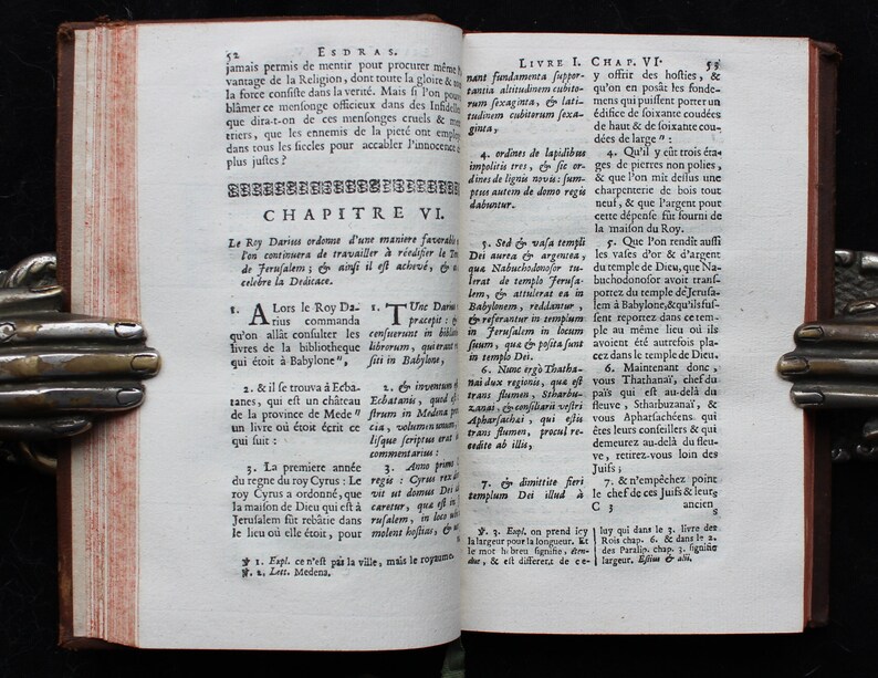 May include: A page from an antique book with text in French. The text is about the rebuilding of the temple in Jerusalem. The page is yellowed with age and has a worn, aged appearance.