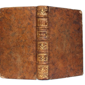 May include: A brown leather-bound book with gold lettering on the spine. The title reads "OEUVRES DE POESIE TOM. I."