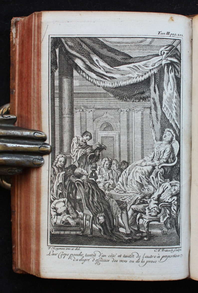 May include: A black and white engraving depicting a group of people in a room. A woman is reclining on a chair, while others are seated or standing around her. The engraving is titled "Leur Corps panche, tantot d'un c&ocirc;t&eacute; et tantot de l'autre &agrave; proportion du degr&eacute; d'efficace des vers ou de la prose."