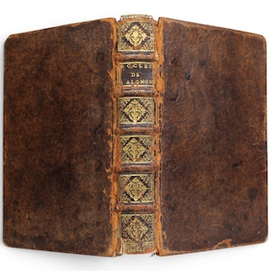 May include: An antique leather-bound book with a dark brown cover and a decorative spine featuring gold-leaf detailing. The spine displays the text ECCLES DE SALOMON in gold lettering, set against a dark background with ornate floral patterns.