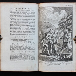 May include: A black and white illustration of three men in a forest setting. The men are dressed in long coats and hats. The man on the right is holding a staff. The illustration is from a book titled "La Dunciade".