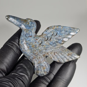 May include: A set of three ceramic mugs with a speckled, matte finish. Each mug features a different color: light blue, cream, and gray. The mugs have a simple, modern design with a rounded shape and a comfortable handle.