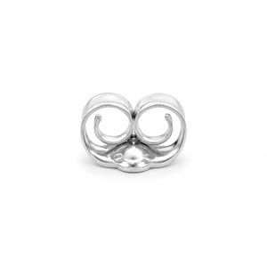 May include: A silver-toned metal earring back featuring a double-loop scroll design. The component has a central circular base with two symmetrical, curved wire loops extending upward, creating a secure friction-fit mechanism for earring posts.