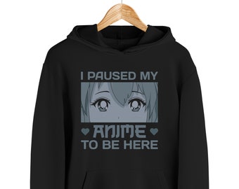 May include: Black hoodie with a white graphic print that says "I paused my anime to be here". The graphic also includes a cartoon anime girl's eyes.