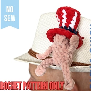 Puede incluir: Un patrón de crochet para un sombrero patriótico fácil y rápido de hacer sin coser, con un sombrero de copa rojo, blanco y azul y una figura de crochet rosa. El patrón es solo para un sombrero, no para la figura.