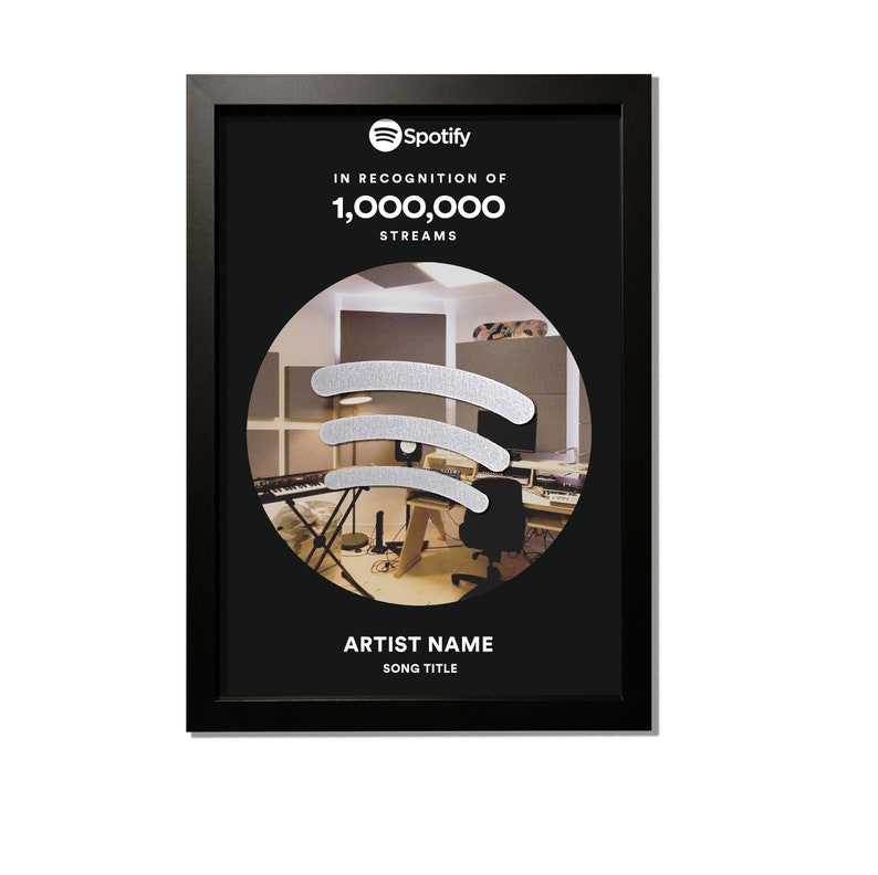 May include: Black framed plaque with a silver Spotify logo and the text "IN RECOGNITION OF 1,000,000 STREAMS". The plaque features a photo of a recording studio with a silver Spotify logo.