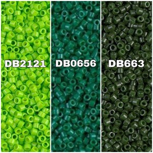 May include: Three different shades of green seed beads. The beads are small and round, and they are arranged in a close-up view. The beads are labeled with the codes DB2121, DB0656, and DB663.