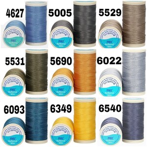 May include: Nine spools of thread in various colors, including blue, gray, brown, green, orange, yellow, and silver. Each spool is labeled with the brand name "mez Nylbond" and the length "60m".
