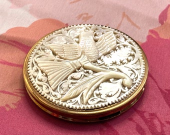 Stunning 1950s English gold tone powder compact with carved composite mother of pearl detailing of a dove with intricate scrollwork. England