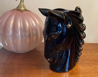 1960s red ware sleek black stallion with gold accents with majestic wavey mane. He is Fiercely confident in his strength and beauty!