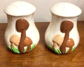 Darling hand painted large 1980s ceramic Mushroom salt and pepper shakers in a retro fungus vibe! The bottom is signed “Block Mom” 1988!