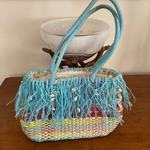 Vintage Artsy Straw Studios weaved beach fringe handbag with conch shells.Pastel colors are striking. This bag is so full of ocean whimsy!