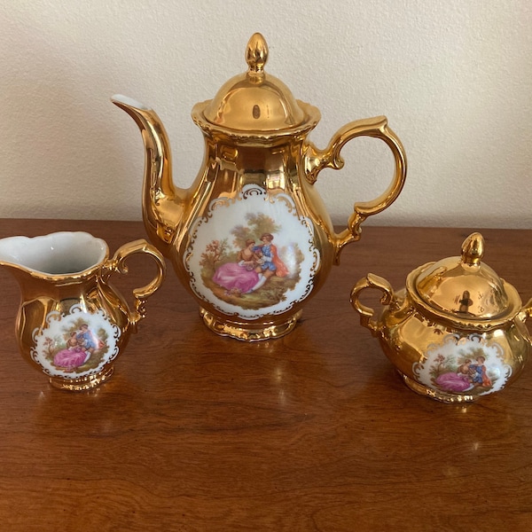 1950s detailed Victorian couple picnicking scene 22k painted tea pot with matching Creamer and sugar bowl in Exceptional condition!