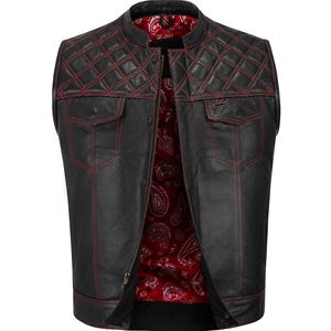 May include: Black leather vest with red stitching and a quilted design on the shoulders. The vest has two front pockets and a red paisley lining. A classic biker-style vest.