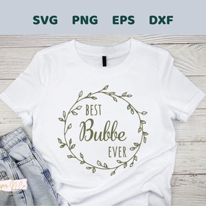 May include: White t-shirt with a green leafy wreath design and the text "Best Bubbe Ever" inside the wreath.