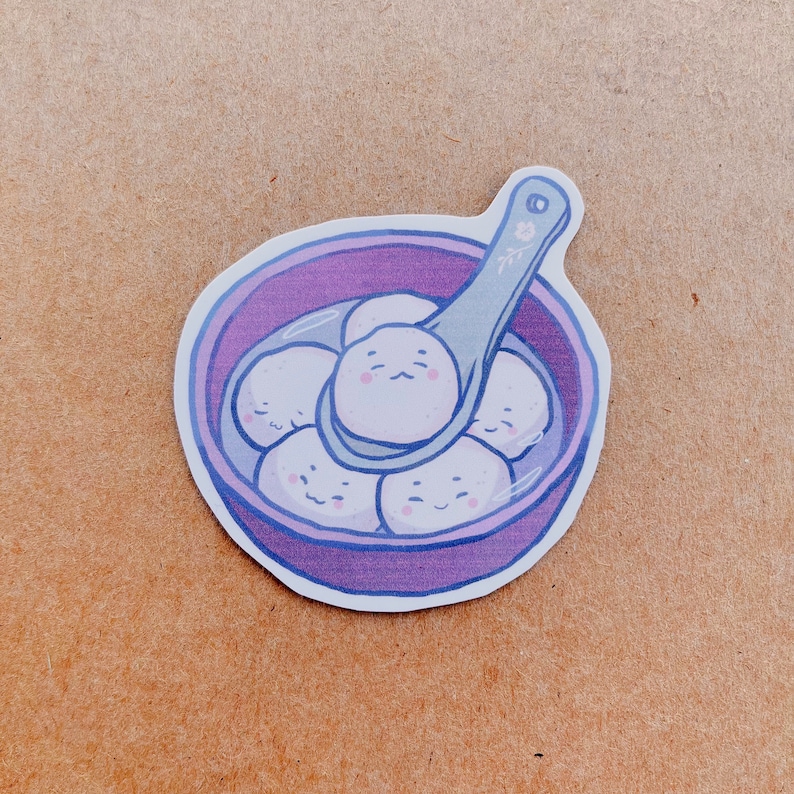 May include: A sticker featuring a purple bowl filled with white, smiling dumplings. A spoon scoops up some of the dumplings. The spoon and bowl have a light purple outline. The sticker has a white border.