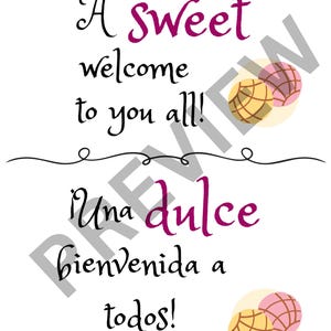 May include: White rectangular sign with the text "A sweet welcome to you all!" in black script and purple cursive. Below, the text "Una dulce bienvenida a todos!" is written in black and purple. Two illustrations of conchas are in the corners.