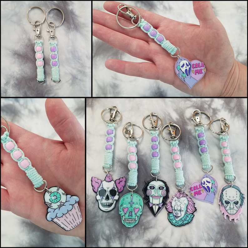 May include: Six different keychain designs featuring various horror movie characters and themes. Each keychain is made with light blue and purple beads and includes a metal ring. The designs include a cupcake with an eye, a skull with a clown face, a skull with a cross, a puppet with a red and black striped shirt, a clown with a red and white striped shirt, and a ghost with the text "Call Me" on a heart.