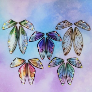 Puede incluir: Surtido de alas de mariposa iridiscentes con una variedad de colores y patrones. Las alas est&aacute;n hechas de un material transl&uacute;cido y tienen un aspecto delicado y et&eacute;reo.