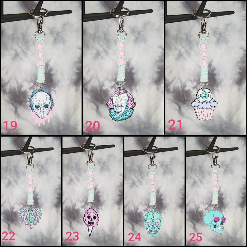 May include: Ten different keychain designs featuring various horror movie characters and spooky themes. Each keychain has a pink and light blue color scheme and a silver key ring.