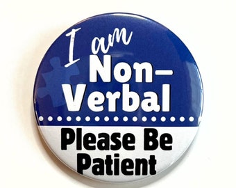 May include: A blue button with white text that reads "I am Non-Verbal Please Be Patient". A blue puzzle piece is in the top left corner of the button.