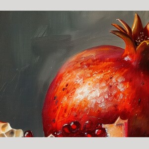May include: A close-up of a red pomegranate with a white, textured surface. The pomegranate is partially cut open, revealing the red seeds inside.