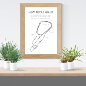 May include: A black and white line drawing of the New Texas Giant roller coaster at Six Flags Over Texas in Arlington, Texas. The drawing includes the name of the ride, the park, and the location. The drawing is framed in a light wood frame and is hanging on a white wall.