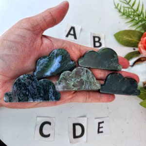 May include: Five green and black cloud-shaped stones with varying patterns. The stones are labeled A, B, C, D, and E.