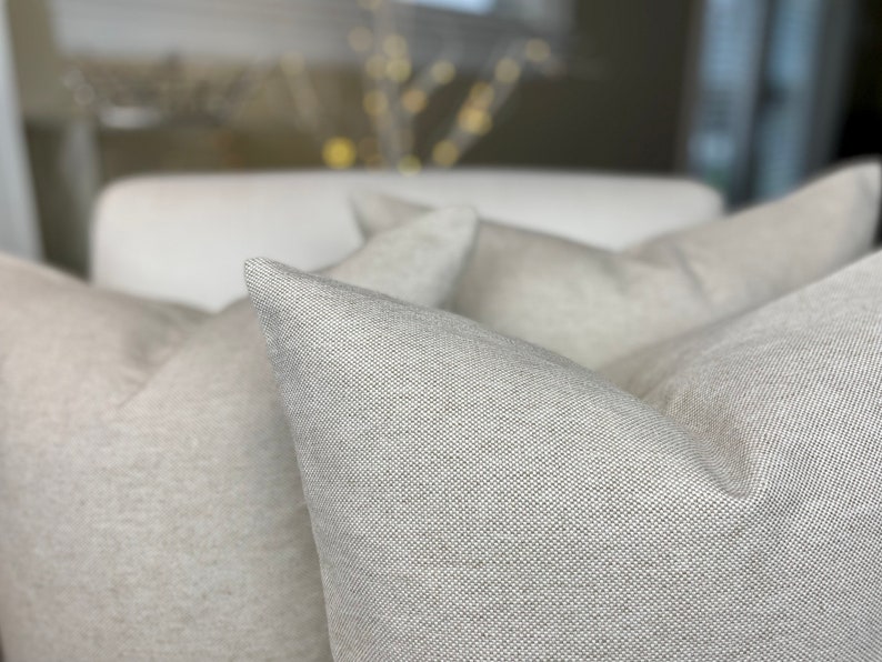 Close up. Cotton linen basket weave blend. Pillow covers with invisible zipper closure. Natural beige colour. Minimalist, modern, rustic , contemporary decor.