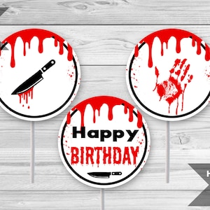 May include: Three round cupcake toppers with a white background and red dripping blood. One topper says "Happy Birthday" with a knife underneath. Another topper has a bloody handprint. The last topper has a knife with a red drip.