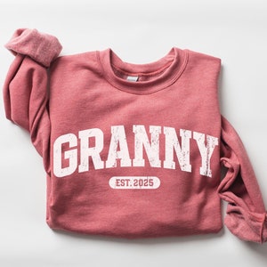 May include: A heather scarlet sweatshirt with the text "Granny Est. 2025" in white.