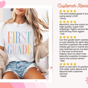 May include: A white short-sleeved t-shirt featuring the text FIRST GRADE printed in large, multicolored pastel letters. The shirt is worn with blue denim shorts and a beige textured cardigan. The image includes a section titled Customer Reviews.