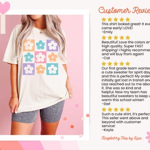 May include: A white t-shirt with a colorful floral pattern. The shirt has a crew neck and short sleeves. The floral pattern is made up of nine squares, each with a different colored flower. The flowers are in shades of pink, blue, orange, and yellow. The shirt is being worn by a person, but the person's face is not visible. The image also includes customer reviews with five-star ratings.