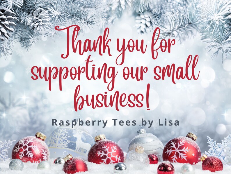 May include: Thank you for supporting our small business! Raspberry Tees by Lisa. A wintery scene with red and silver ornaments on a snowy surface.
