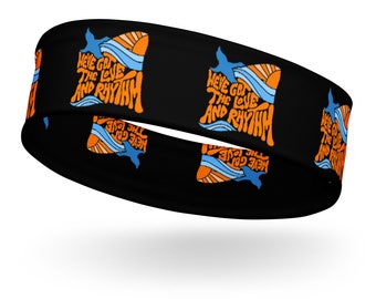 May include: Black headband with a repeating pattern of orange and blue waves and the text "We've got the love and rhythm".