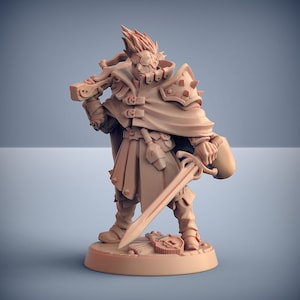 May include: A miniature figurine of a fantasy character wearing a brown cloak and holding a sword and a shield. The figurine is made of a light brown plastic and is standing on a round base.
