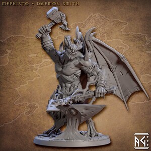 May include: A gray, detailed miniature sculpture of a demon with wings, holding a hammer and a sword, standing on an anvil. The sculpture is on a round base.