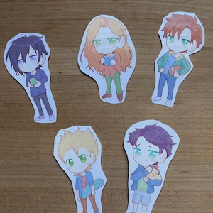 May include: Five cartoon character stickers with different colored hair and clothing. The characters are holding a frog, a book, a football, a chicken, and a skateboard.