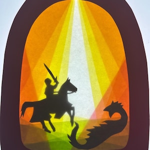 May include: A paper cutout art piece featuring a dark brown arched frame. Inside, black silhouettes depict a knight on horseback holding a sword, facing a dragon. The background consists of layered translucent paper in shades of yellow and orange.