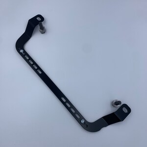 Toyota GT86 fire extinguisher holder bracket mounted on OEM seat rails. Ensure safety with easy access to the fire extinguisher while driving. A reliable addition to your GT86 for emergency situations