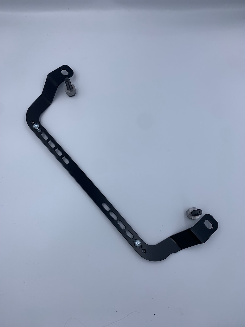 Toyota GT86 fire extinguisher holder bracket mounted on OEM seat rails. Ensure safety with easy access to the fire extinguisher while driving. A reliable addition to your GT86 for emergency situations