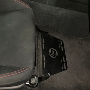 Toyota GT86 fire extinguisher holder bracket mounted on OEM seat rails. Ensure safety with easy access to the fire extinguisher while driving. A reliable addition to your GT86 for emergency situations
