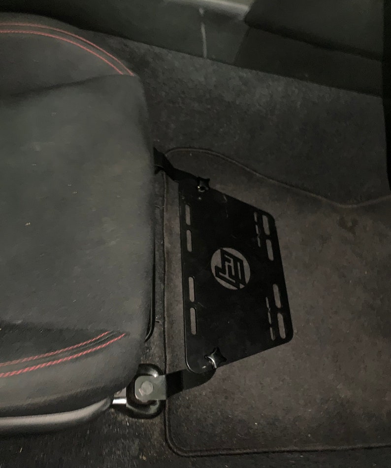 Toyota GT86 fire extinguisher holder bracket mounted on OEM seat rails. Ensure safety with easy access to the fire extinguisher while driving. A reliable addition to your GT86 for emergency situations