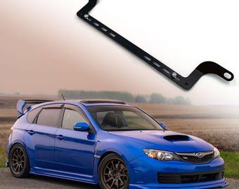May include: A blue Subaru Impreza WRX with a black metal roof rack. The roof rack is designed to hold cargo on top of the car.