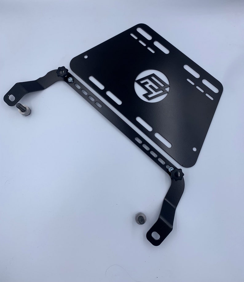 Toyota GT86 fire extinguisher holder bracket mounted on OEM seat rails. Ensure safety with easy access to the fire extinguisher while driving. A reliable addition to your GT86 for emergency situations