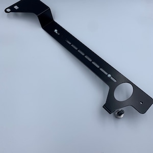 Nissan GTR R35 fire extinguisher holder bracket mounted on OEM seat rails. Ensure safety with this easy-to-access and sturdy bracket for emergencies. Perfect fit for your GTR R35