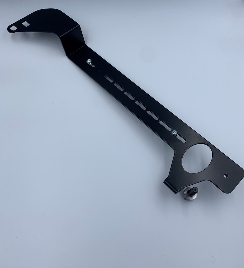 Nissan GTR R35 fire extinguisher holder bracket mounted on OEM seat rails. Ensure safety with this easy-to-access and sturdy bracket for emergencies. Perfect fit for your GTR R35